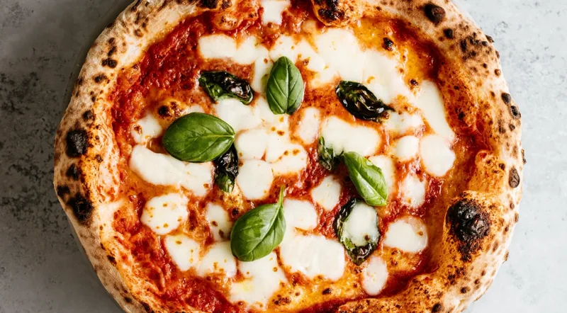 A finished Roman-style margherita pizza, top down