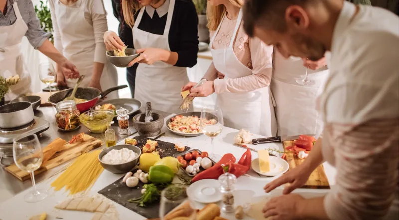 A group cooking class in Rome with wine and fresh ingredients on the table