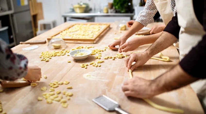 Students shaping fresh pasta by hand at a Rome cooking class